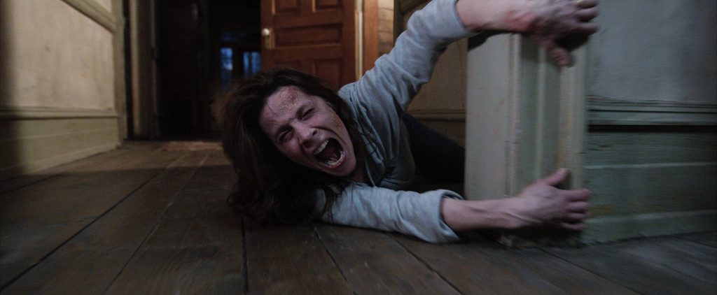 Ed and Lorraine Warren investigating paranormal activity in The Conjuring
