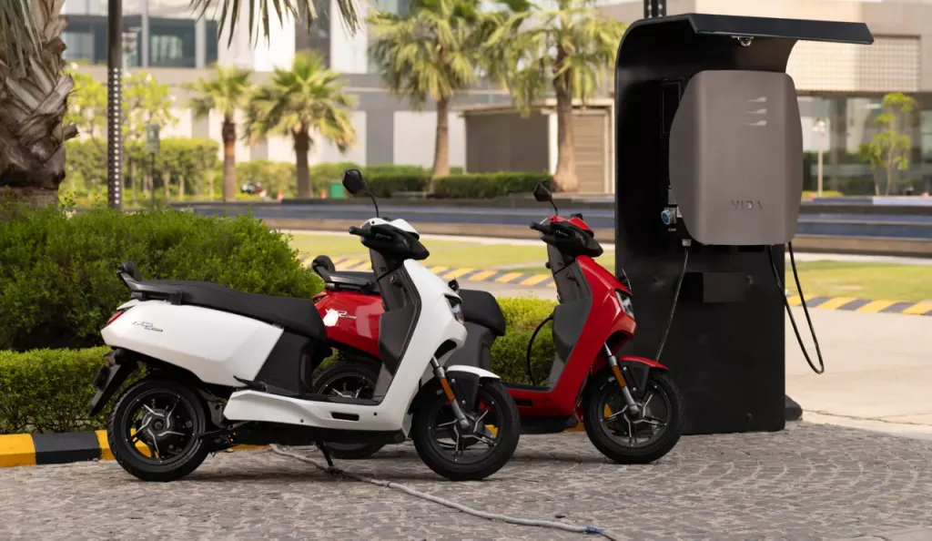 Vida V2 Plus plugged into a public fast charging station for quick top‑up